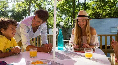 Famille sur la terrasse de leur mobil home Domaine de Soulac
